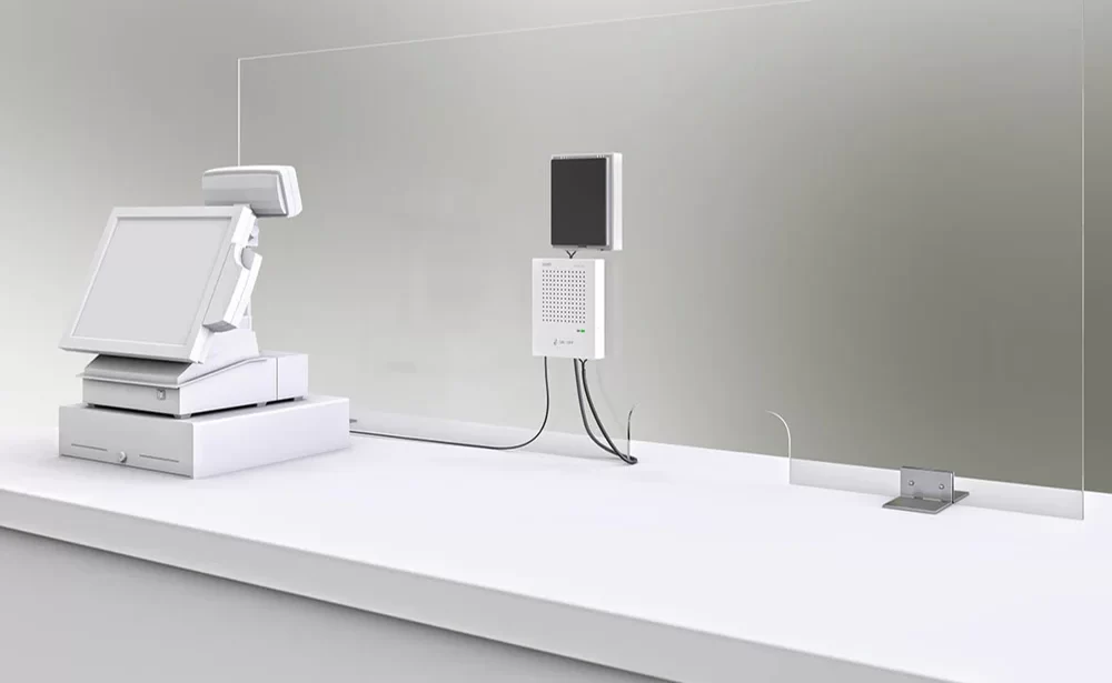 Close-up shot of a VoiceBridge Contactless Intercom System for Screens fitted to a Perspex Glass Screen